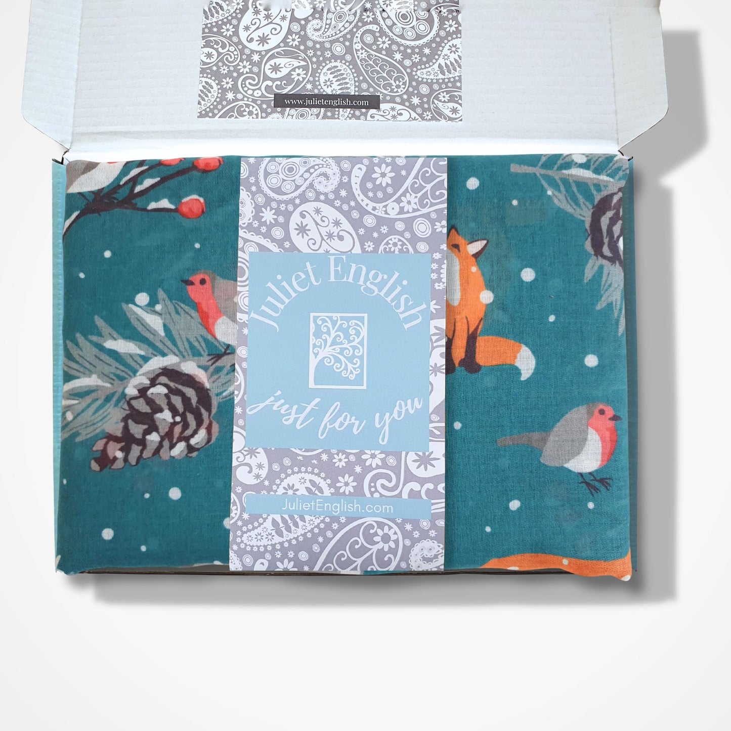 Packaged scarf with a colorful design featuring animals and text on a white background