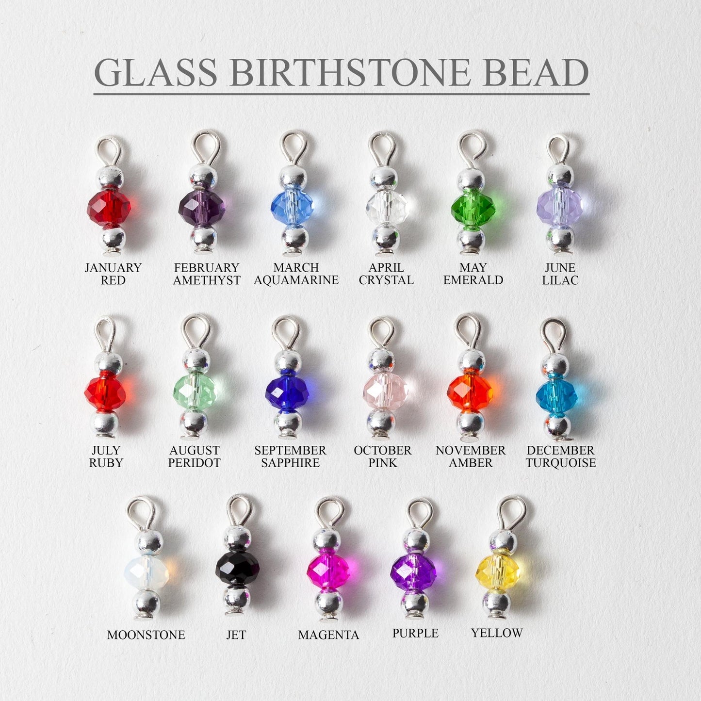 Glass birthstone beads with corresponding months on a white background