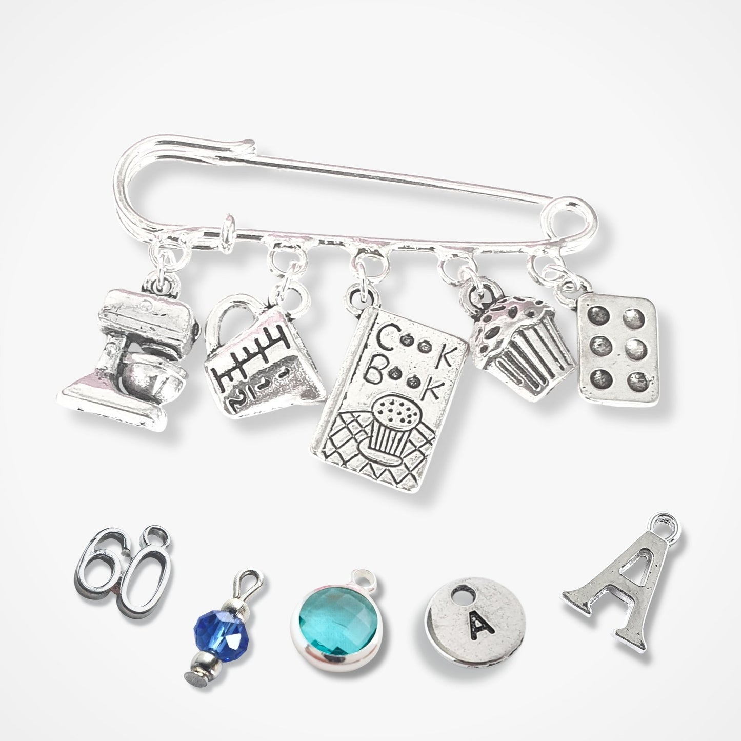 Silver charm bracelet with various charms on a white background
