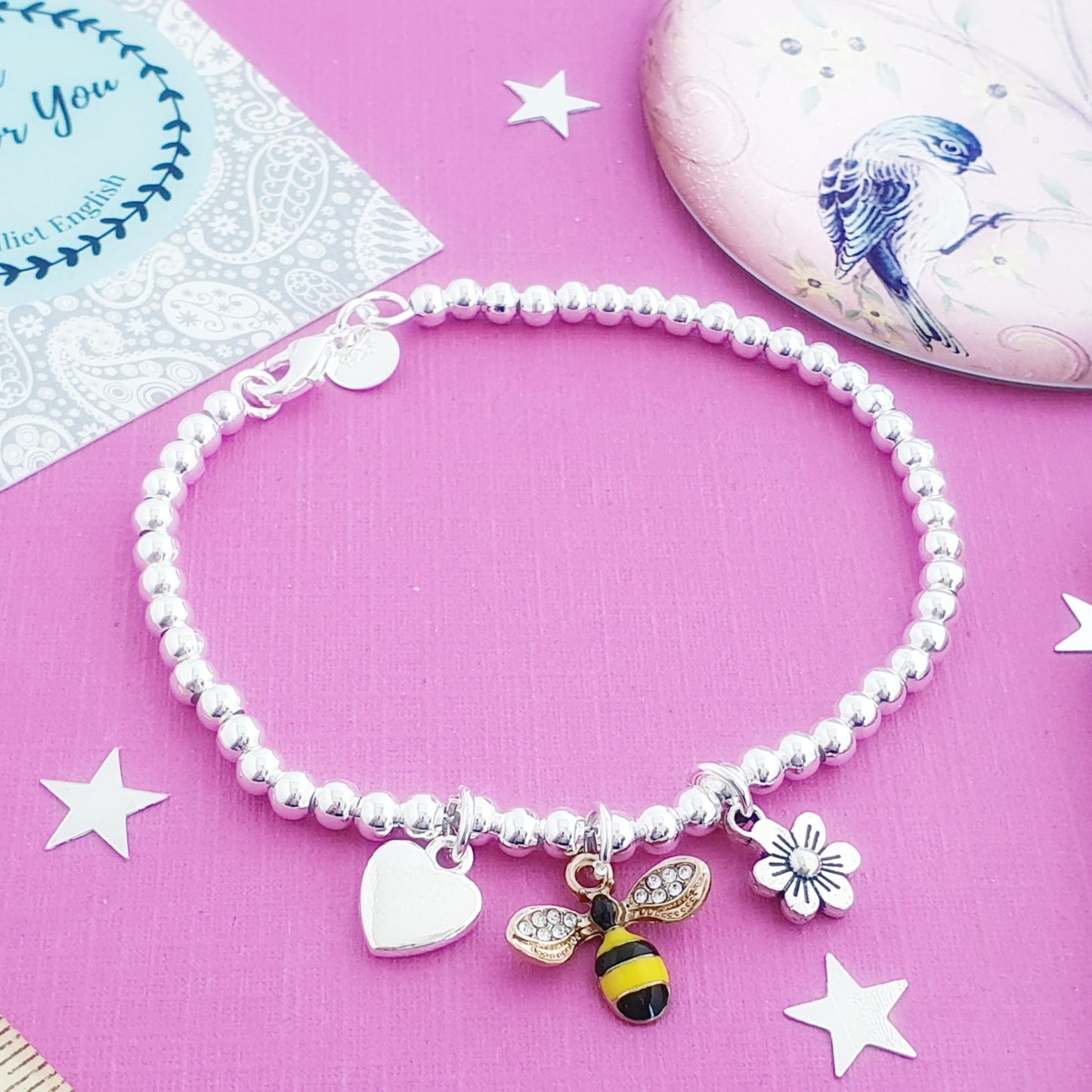 Bracelet with charms on a pink background