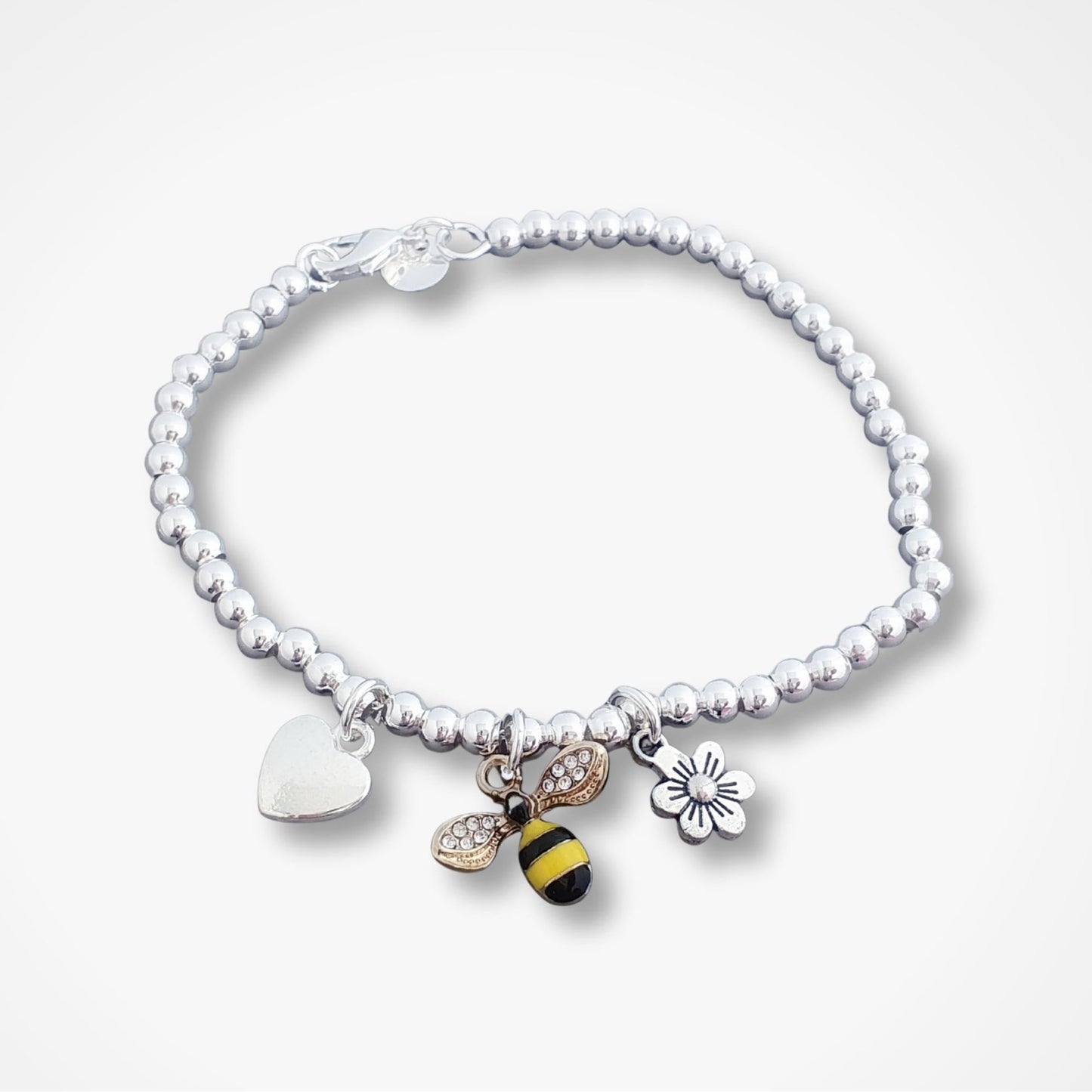 Bracelet with various charms including a bee on a white background