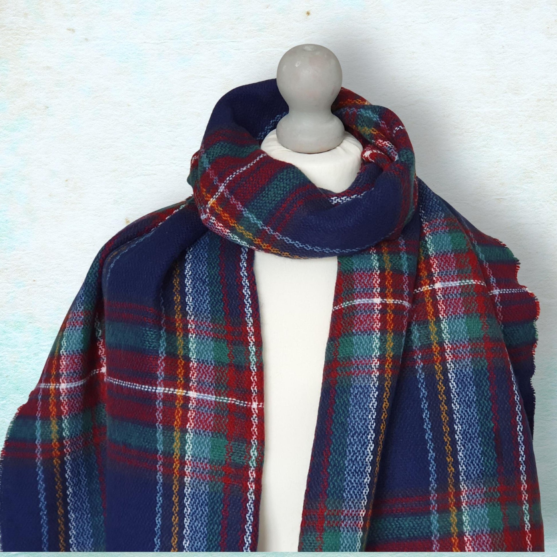 Plaid scarf draped over a mannequin against a light background