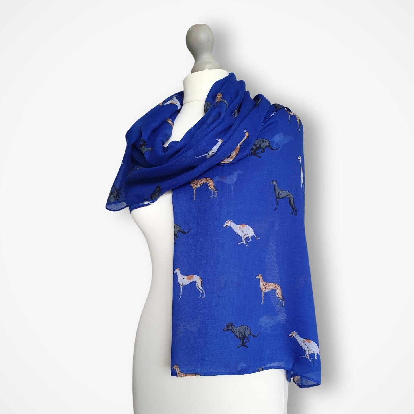 Blue scarf with whippet pattern on a mannequin against a white background