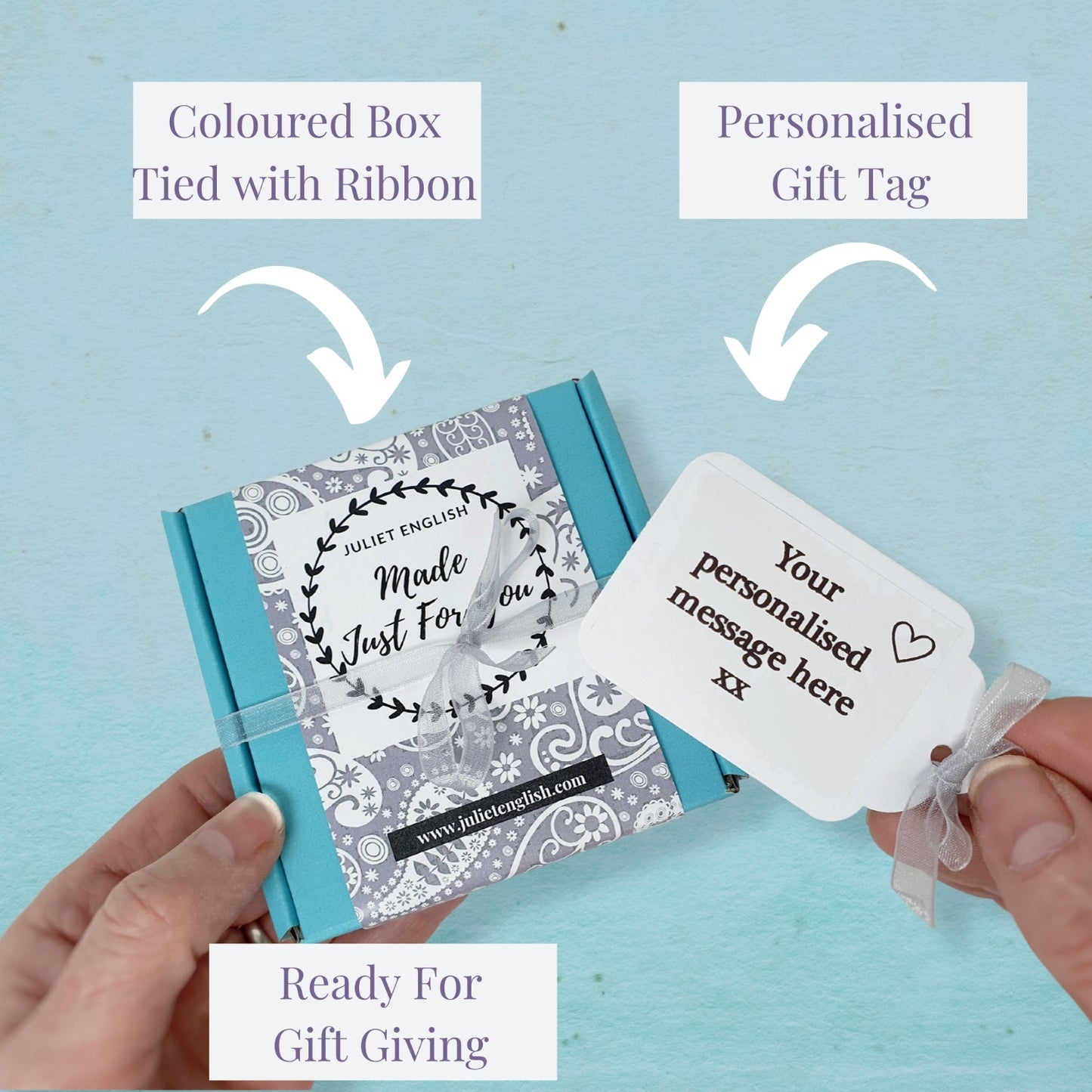 Gift box with a personalized gift tag on a light blue background