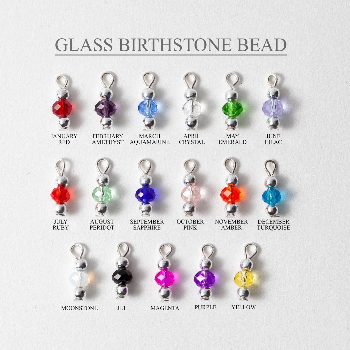 Glass birthstone beads with corresponding months on a white background