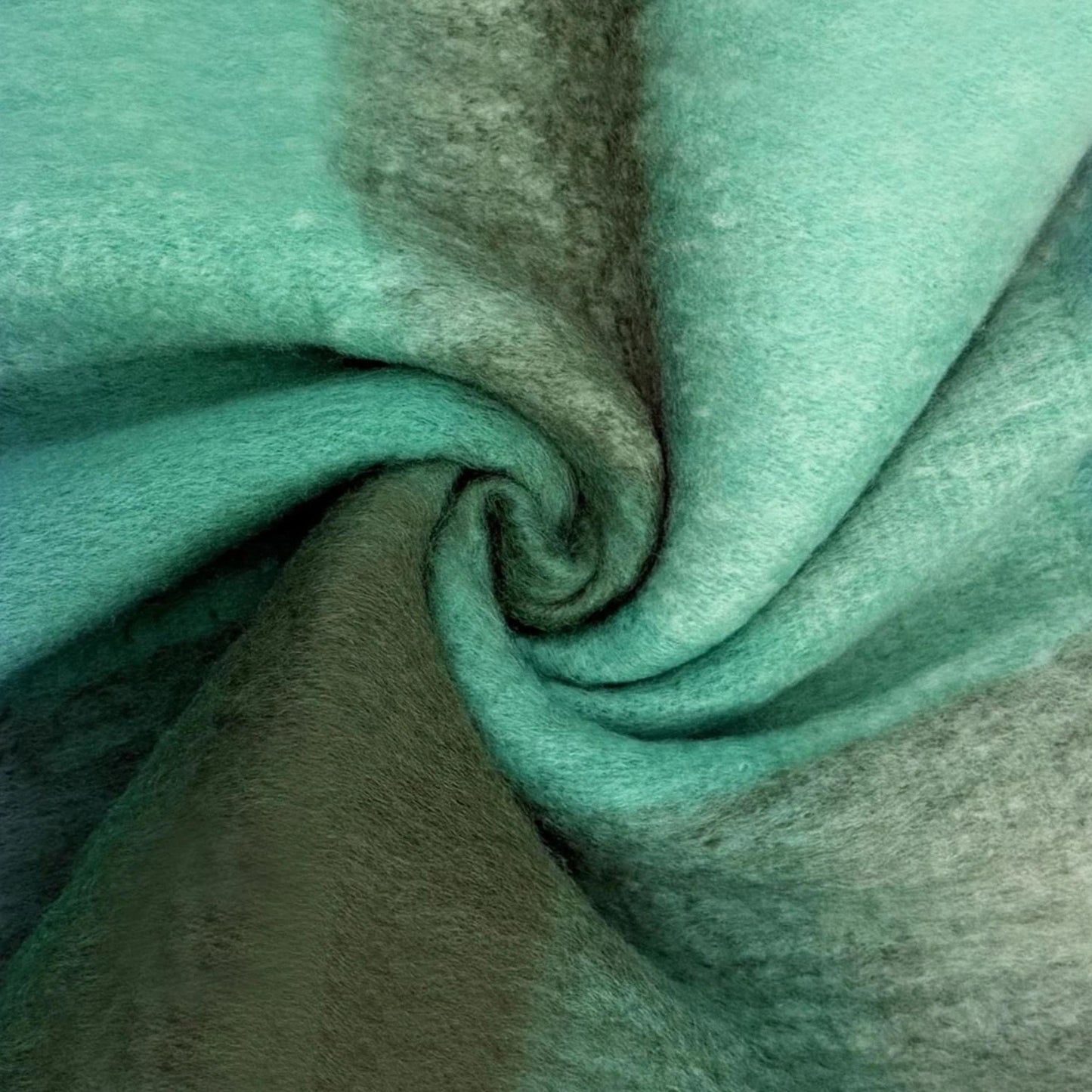 Close-up of teal green scarf fabric with a slight texture