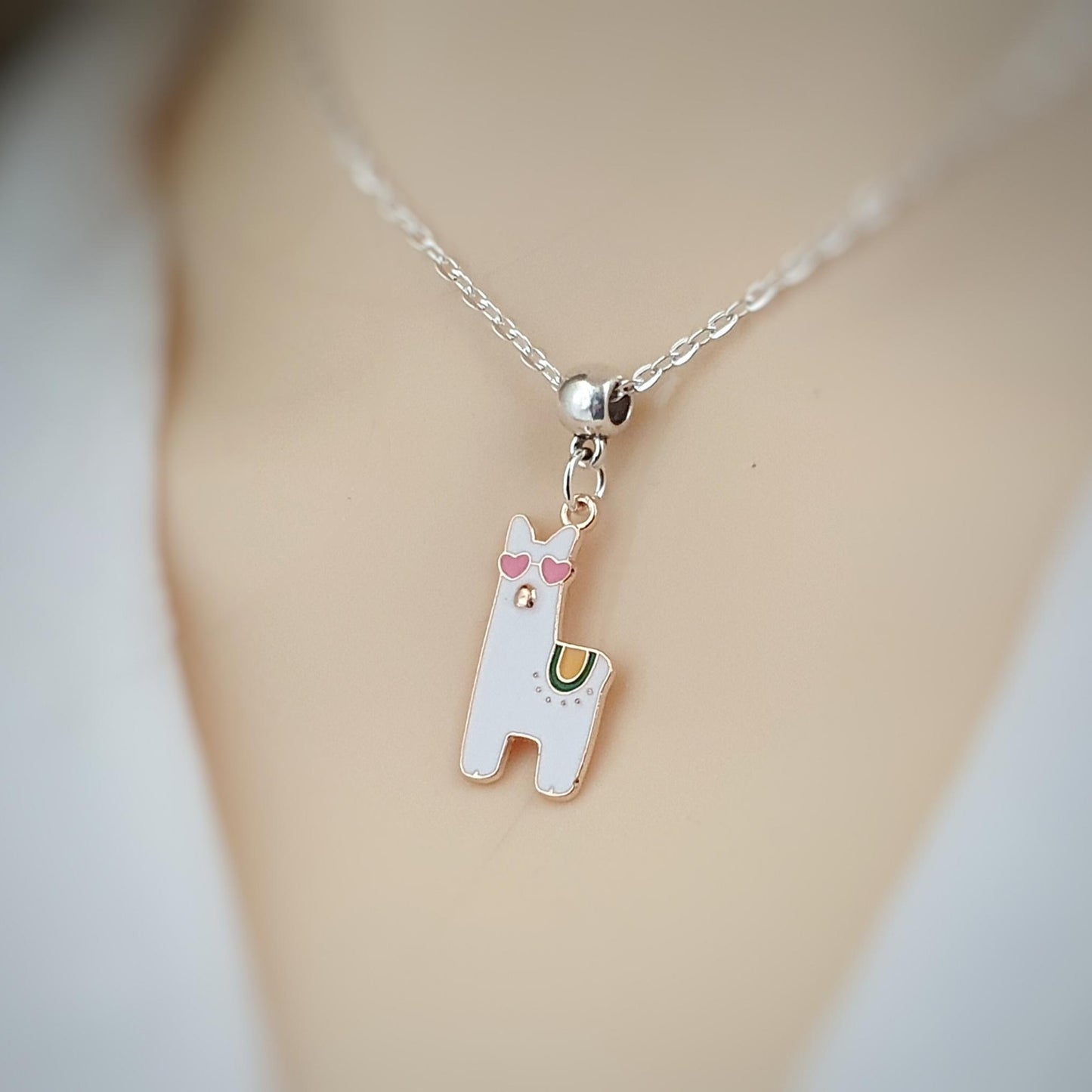 Necklace with a llama-shaped pendant on a blurred background