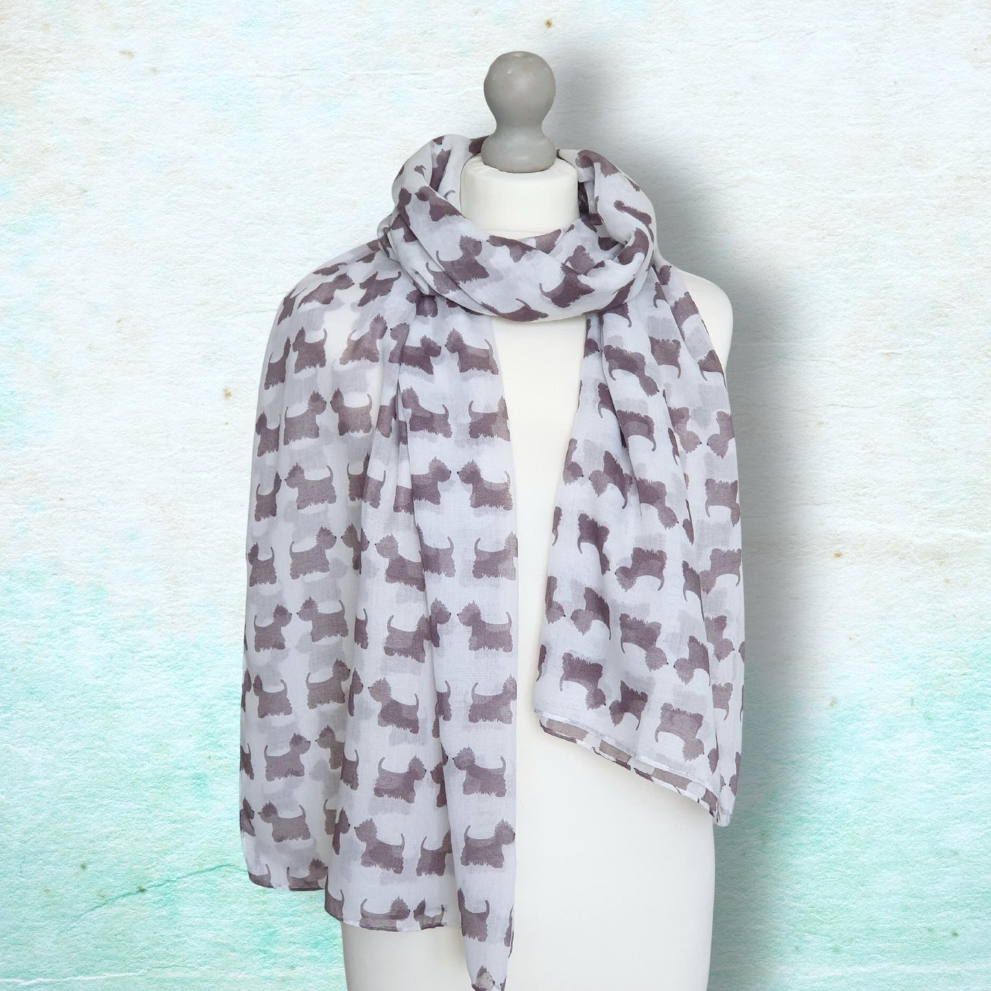 Scarf with dog pattern on a mannequin against a light blue background