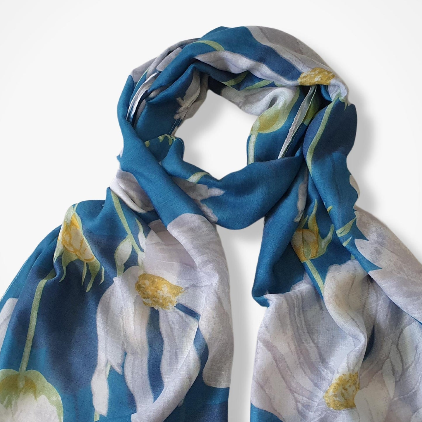 Floral patterned scarf with blue, white, and yellow colors on a white background