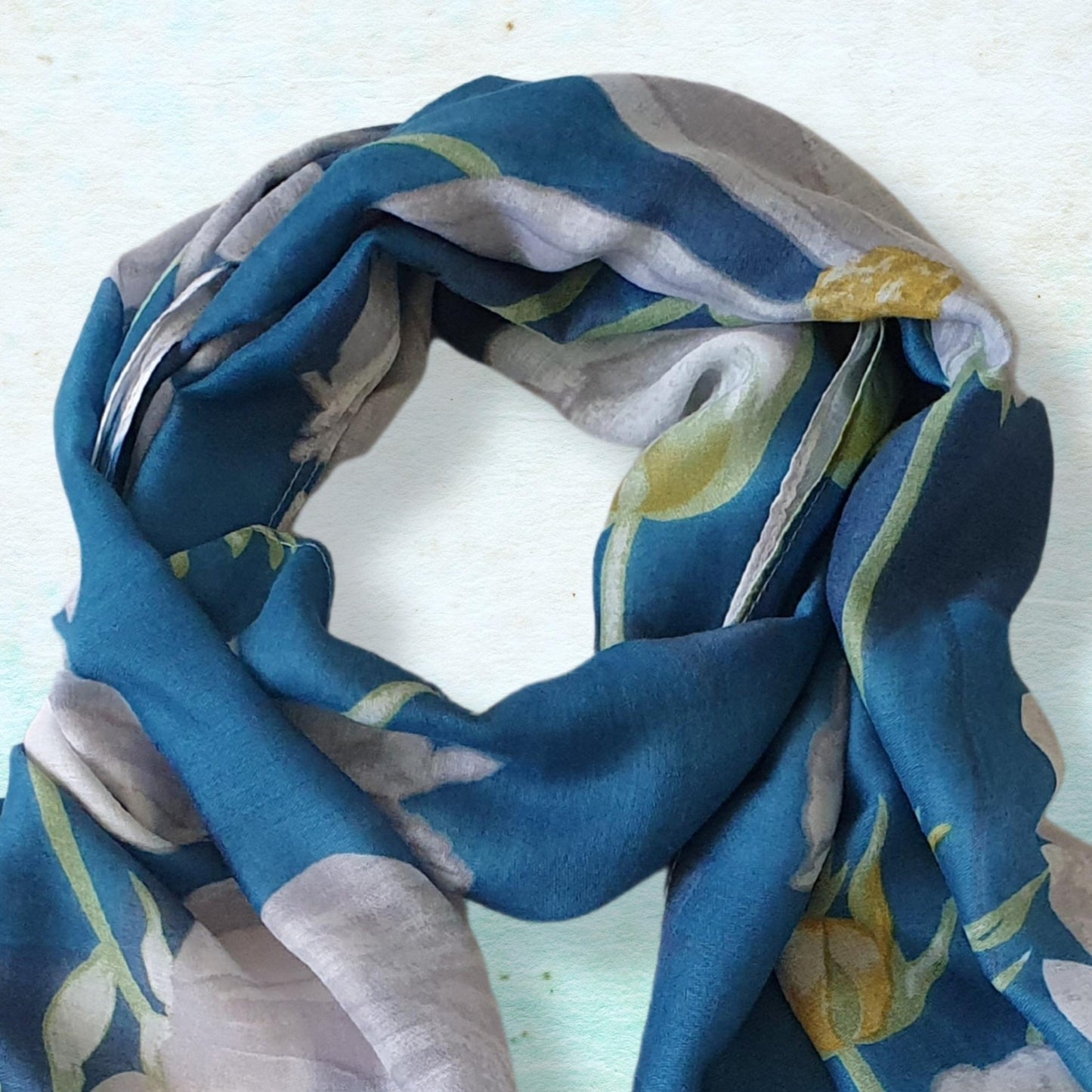 Colorful floral scarf on a light blue background