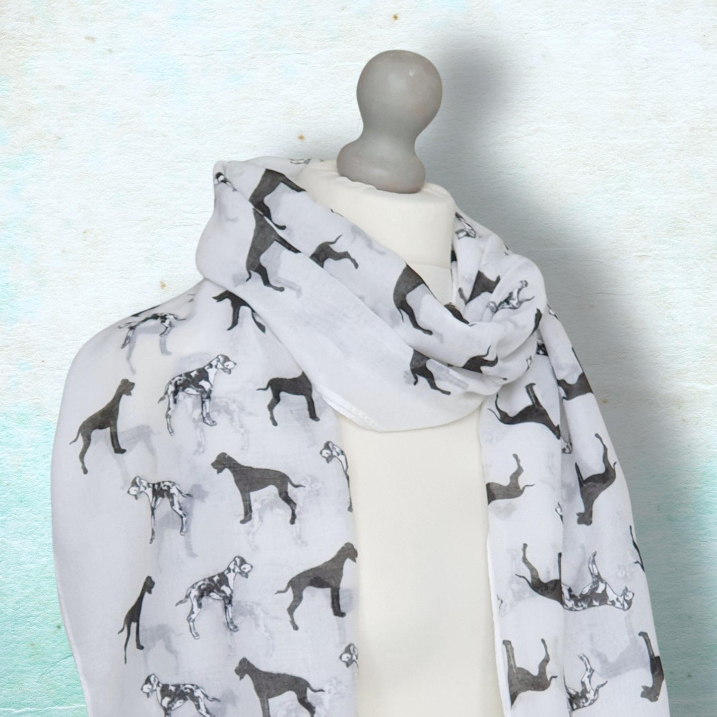 Scarf with great dane dog pattern on a mannequin against a light background