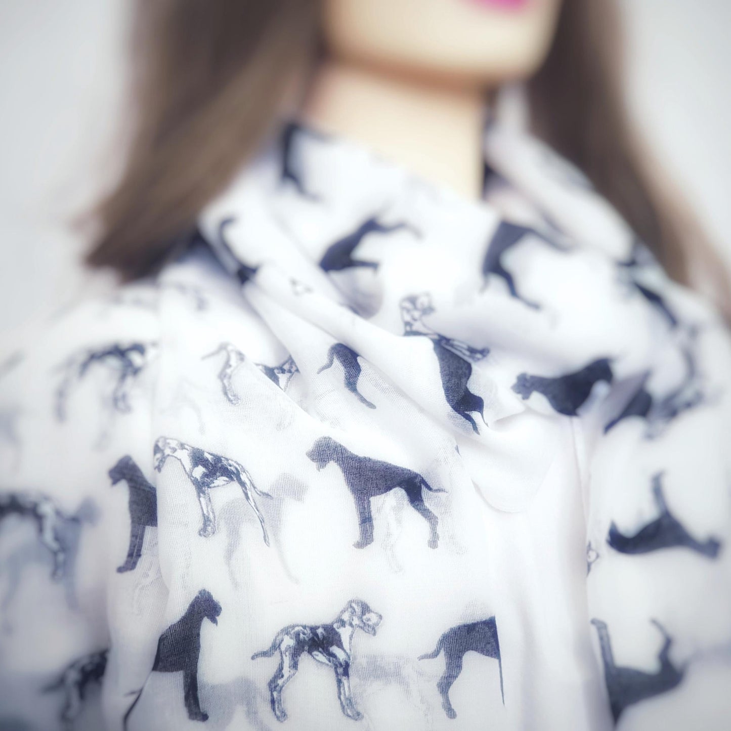 Person wearing a scarf with great dane dog pattern
