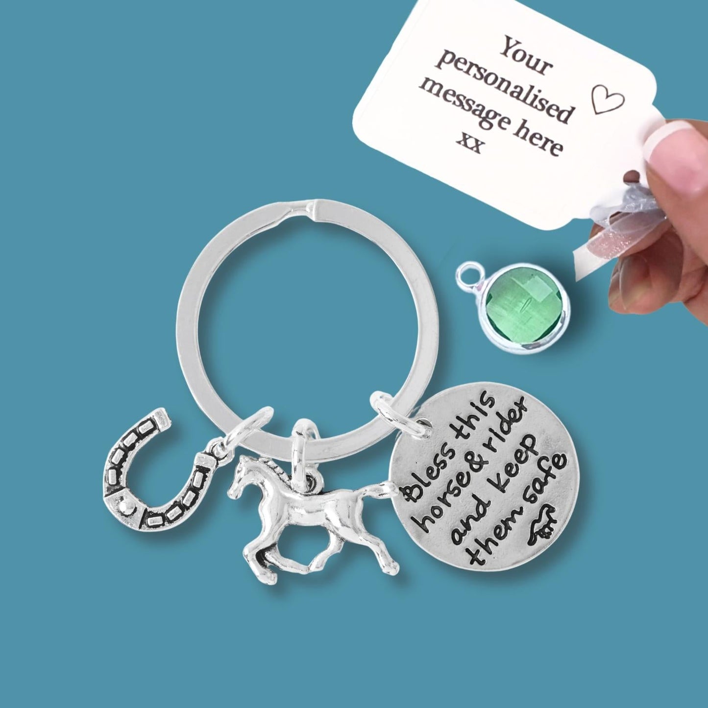 Silver keychain with horse and rider charm and engraved message on a blue background