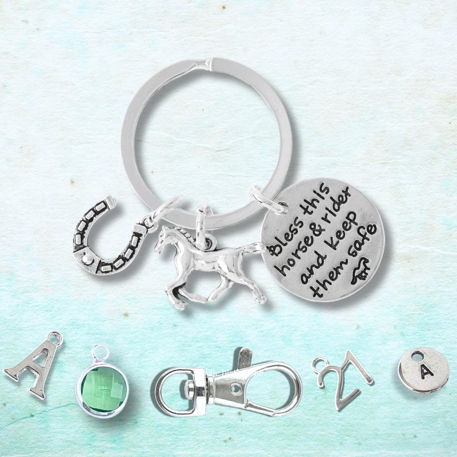 Silver keychain with charms on a light blue background