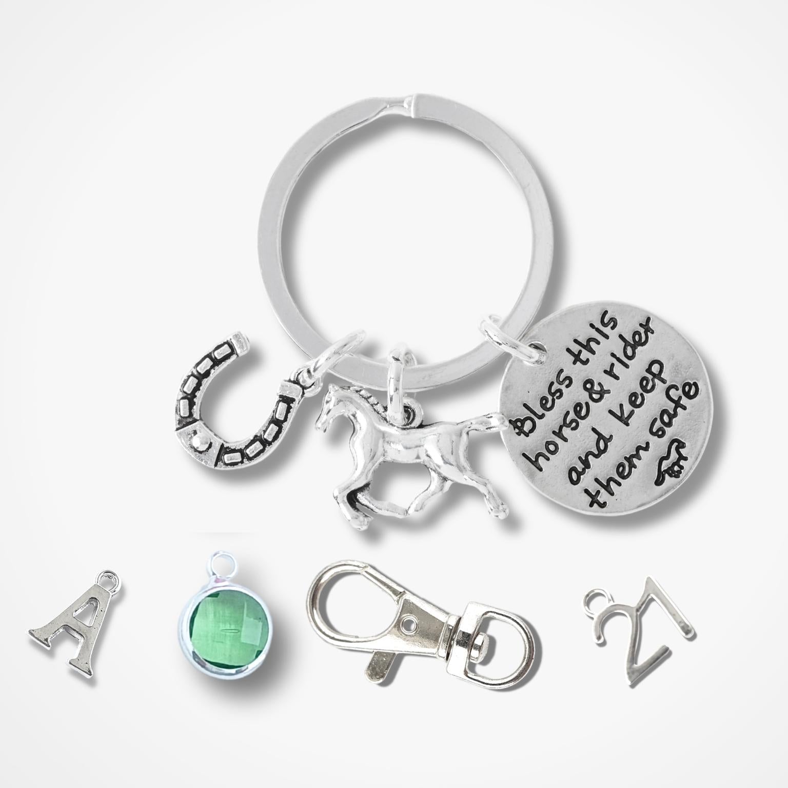 Silver keychain with various charms on a white background