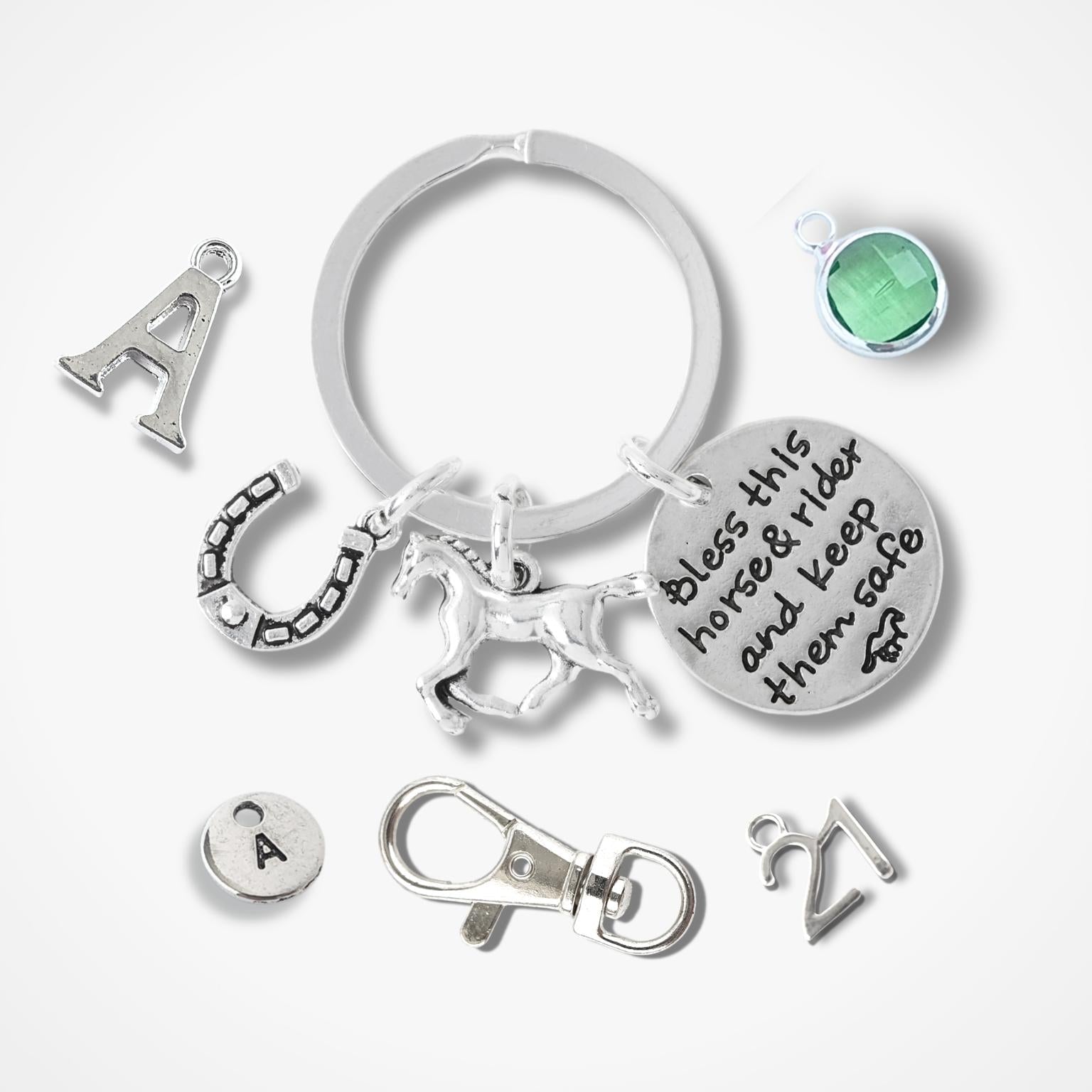 Silver keychain with various charms on a white background