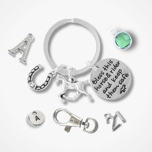 Silver keychain with various charms on a white background