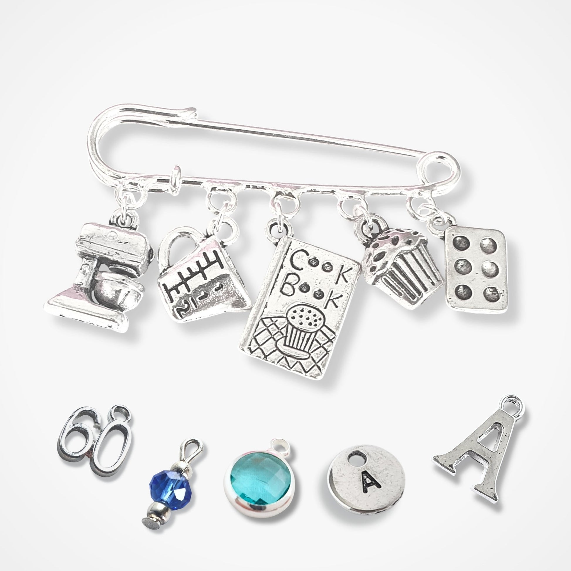 Silver charm bracelet with various charms on a white background