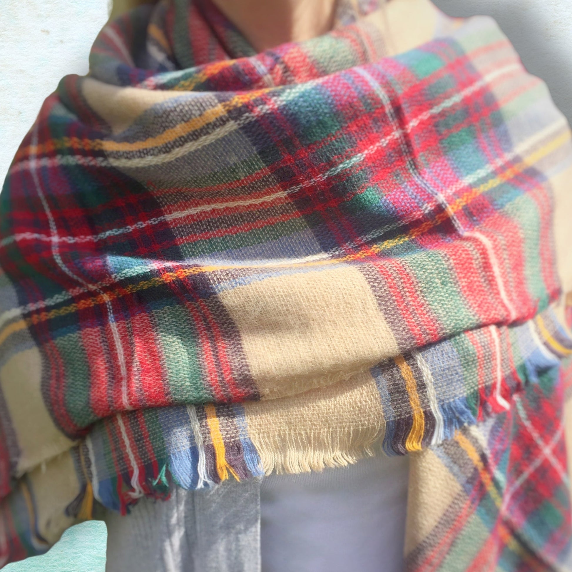 Multicolored plaid scarf on a neutral background