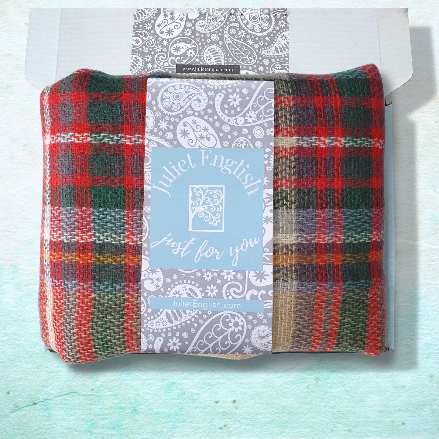 Plaid fabric in a package with a label on a light blue background