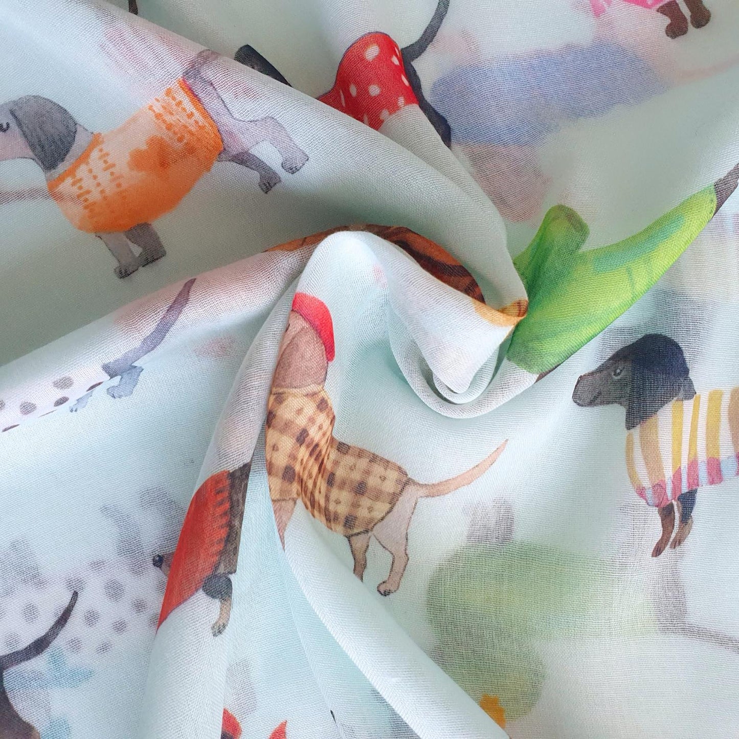 Fabric with colorful dog illustrations on a white background