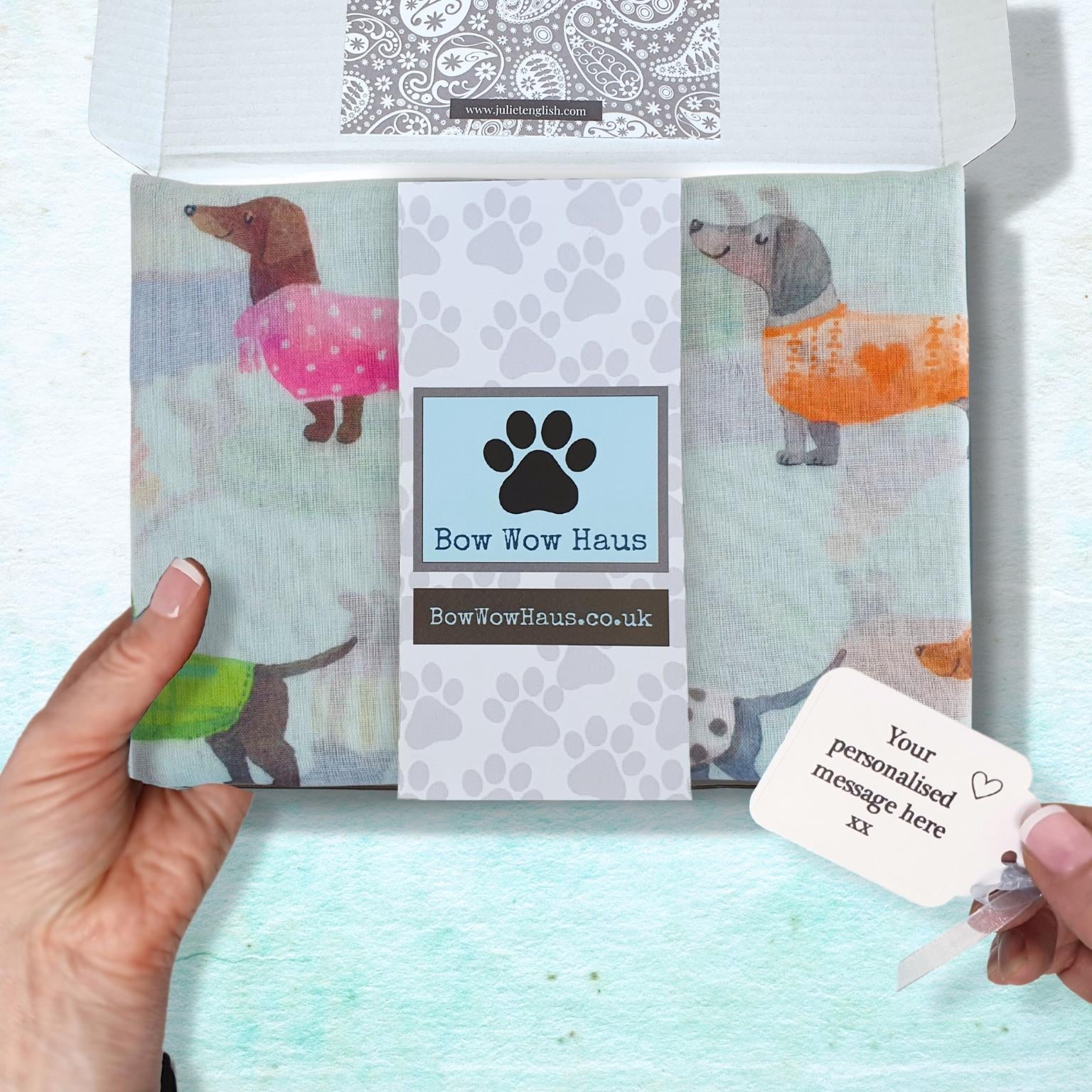 Packaged product with 'Bow Wow Haus' branding and a personalized message card on a light blue background.