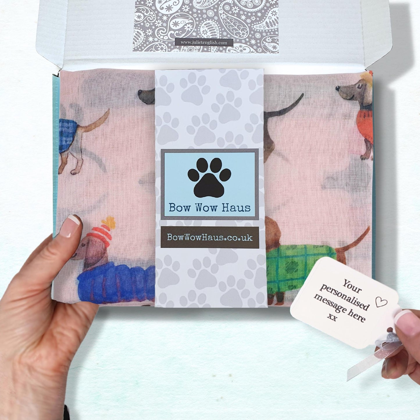 gift boxed dog print scarf with a personalized message card held by a hand.