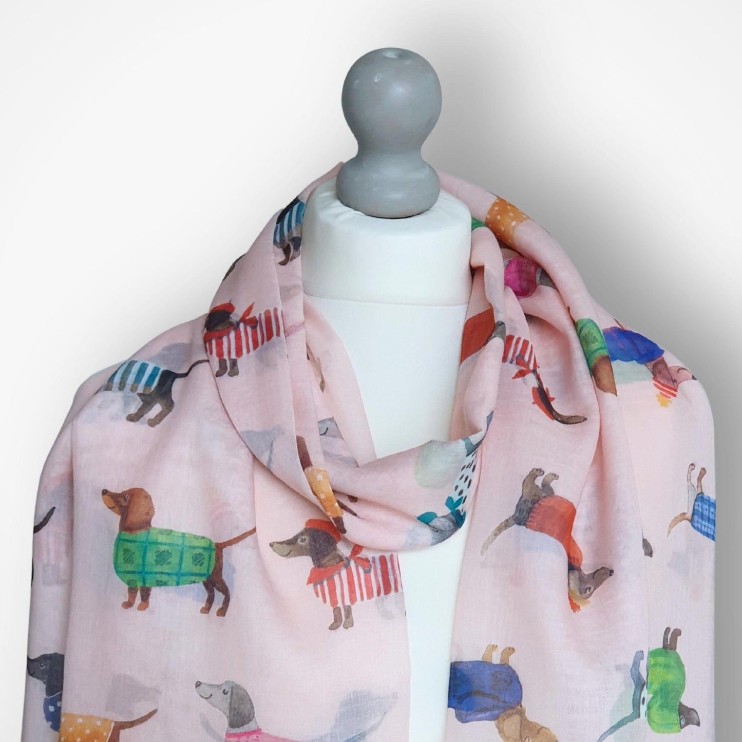 Scarf with dog pattern on a mannequin against a white background