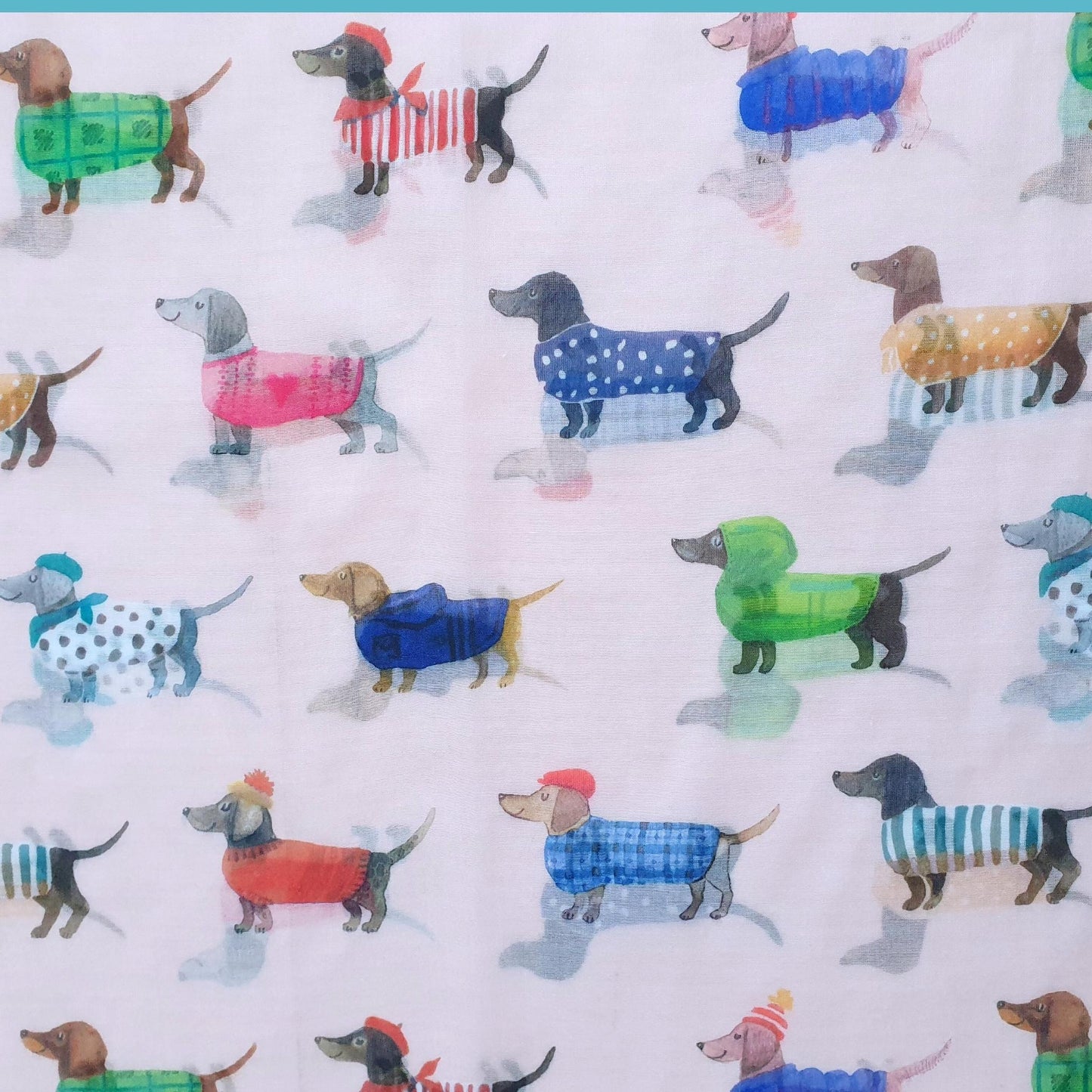 Pattern of small dogs in colorful outfits on a white background