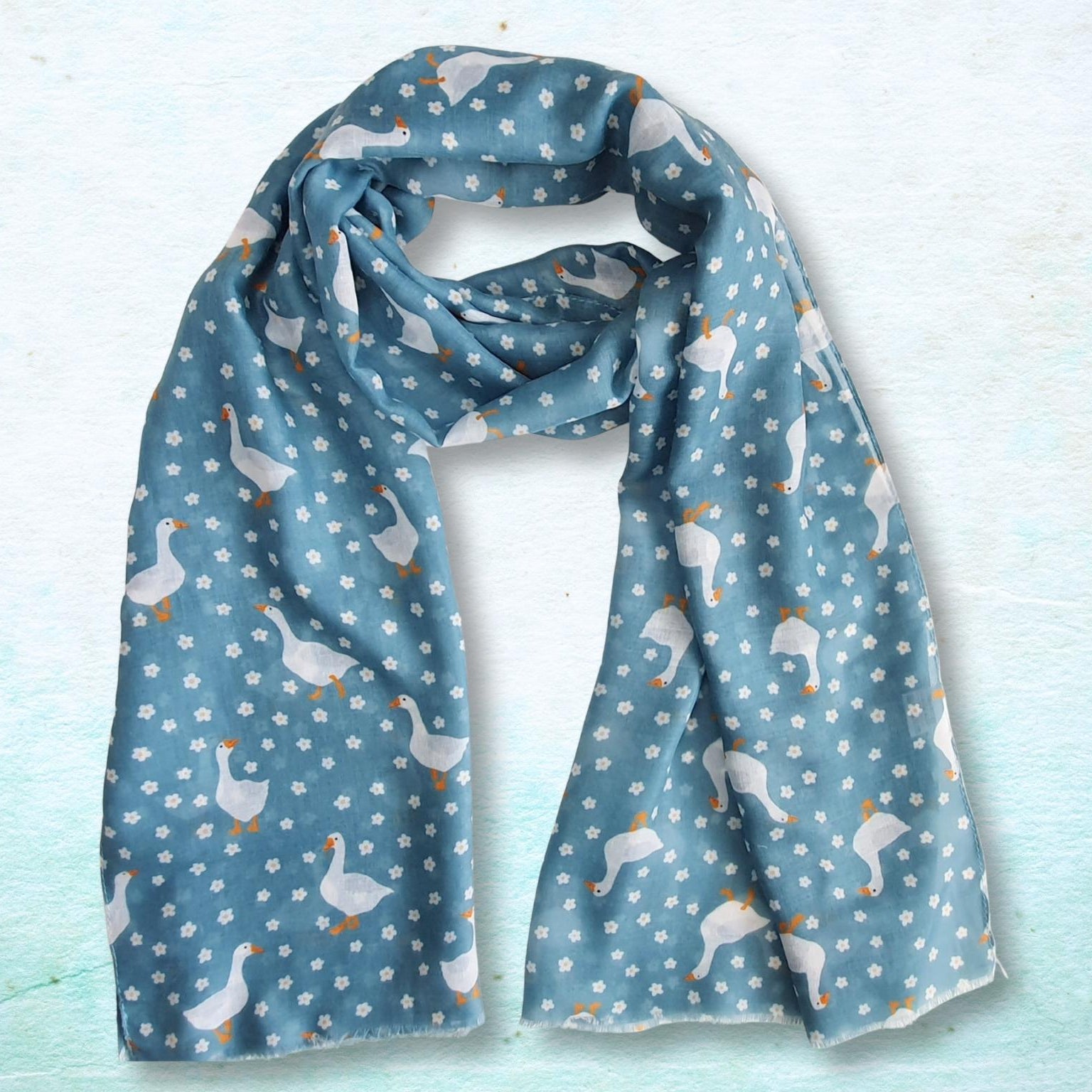 Blue scarf with duck pattern on a light blue background