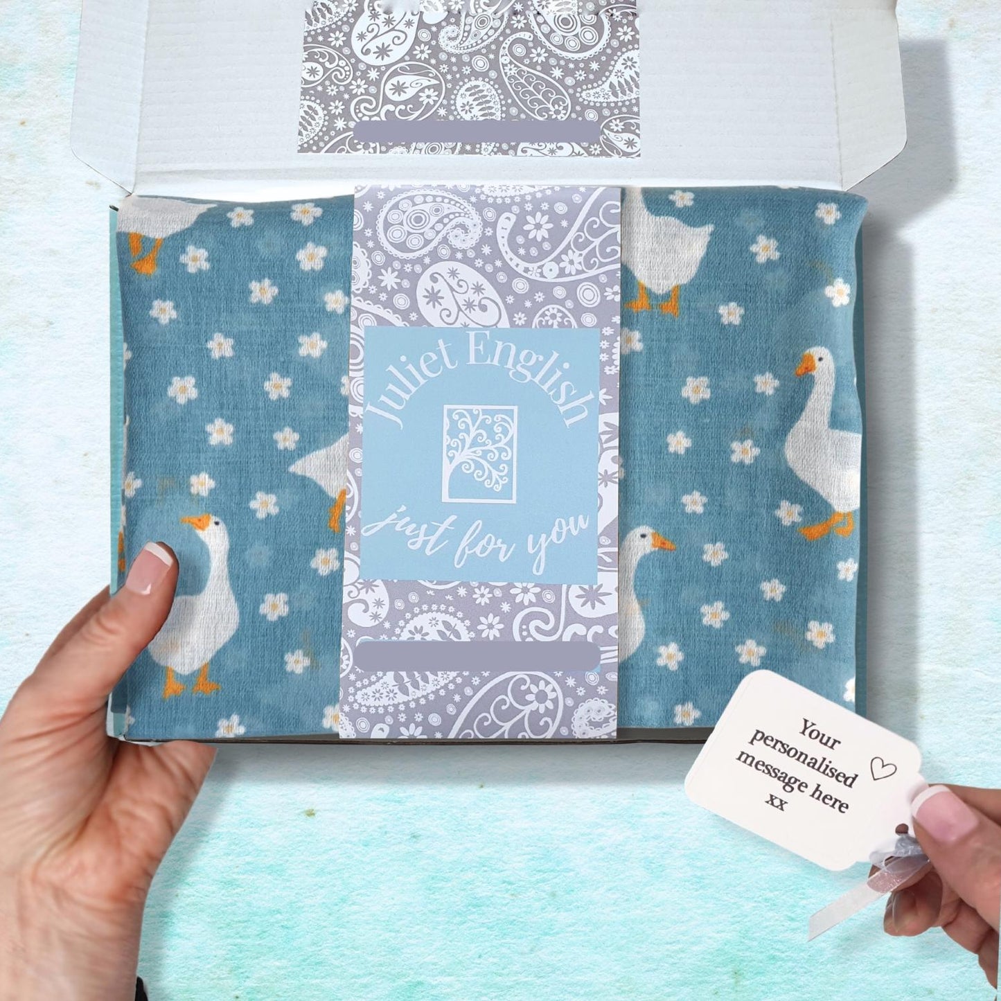 Packaged product with a personalized message card on a light blue background
