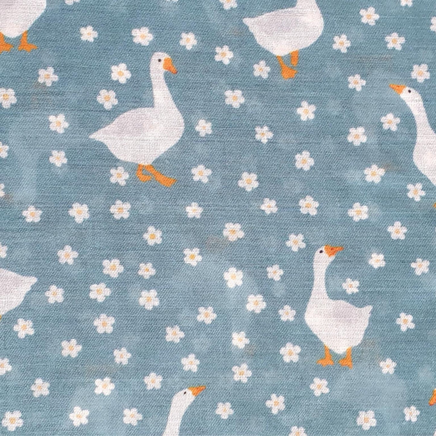 Pattern of geese and flowers on a blue background
