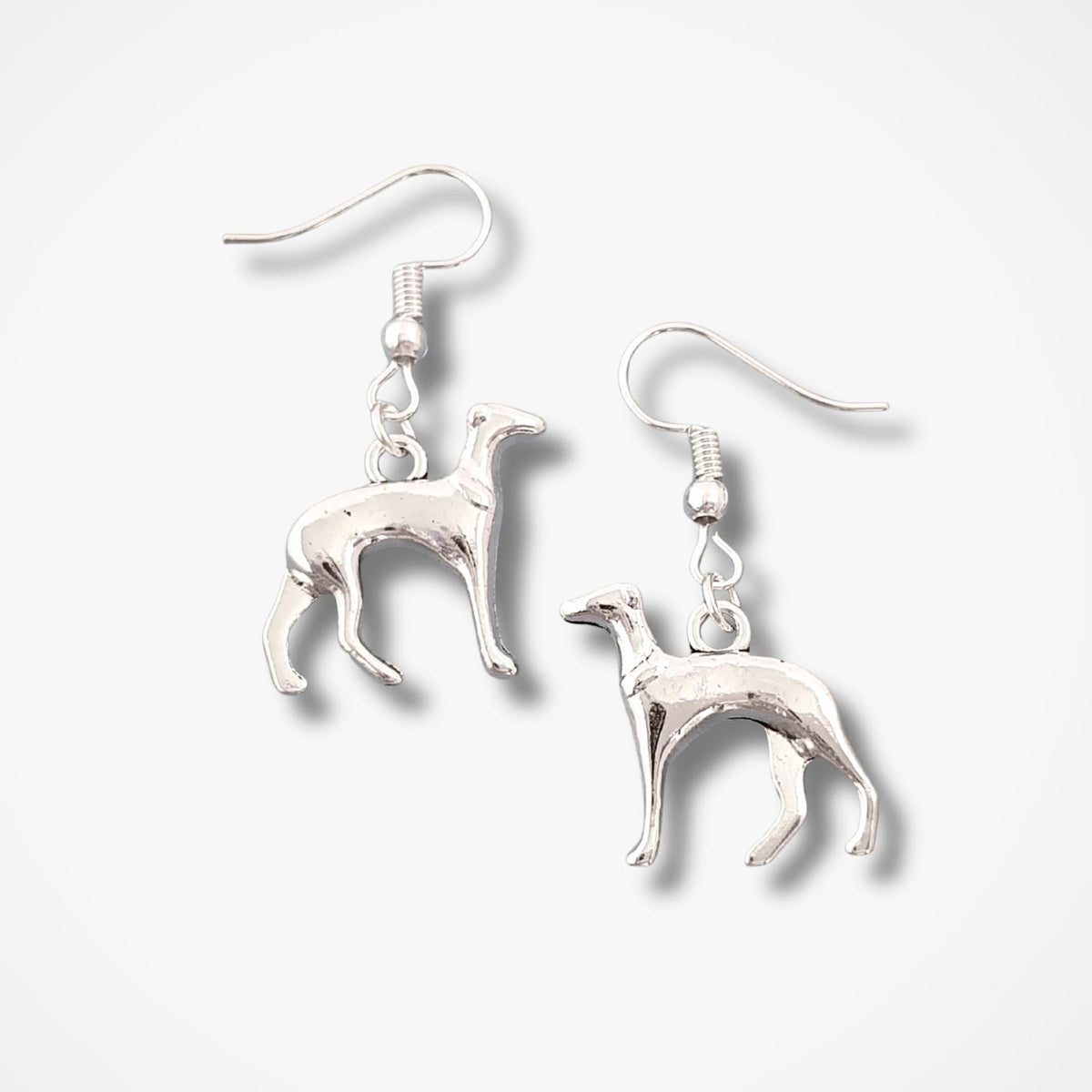 A pair of  dangle earrings shaped like greyhounds, shown on a clean white background with soft drop shadows.