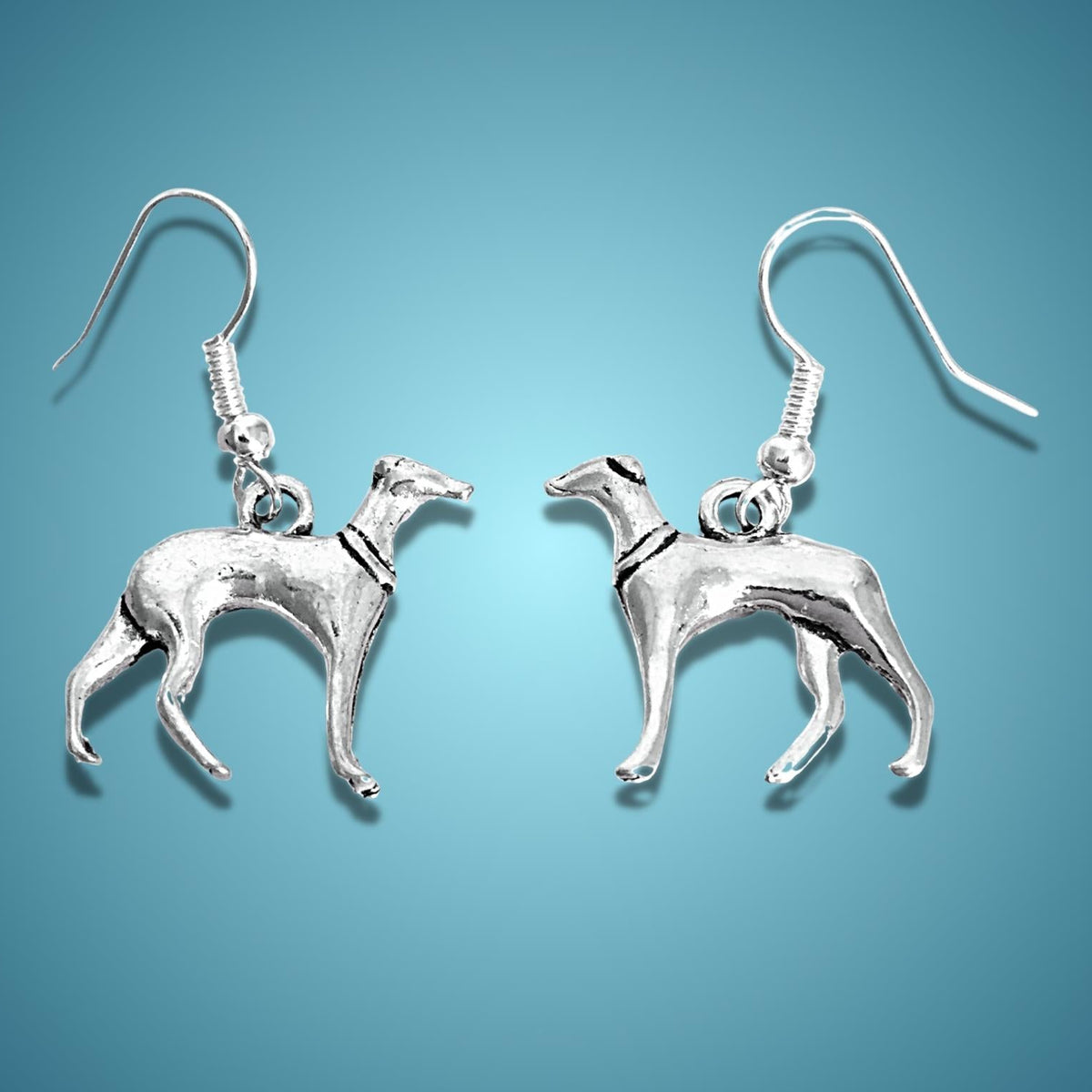 A pair of dangle earrings shaped like greyhounds, shown against a solid blue gradient background.