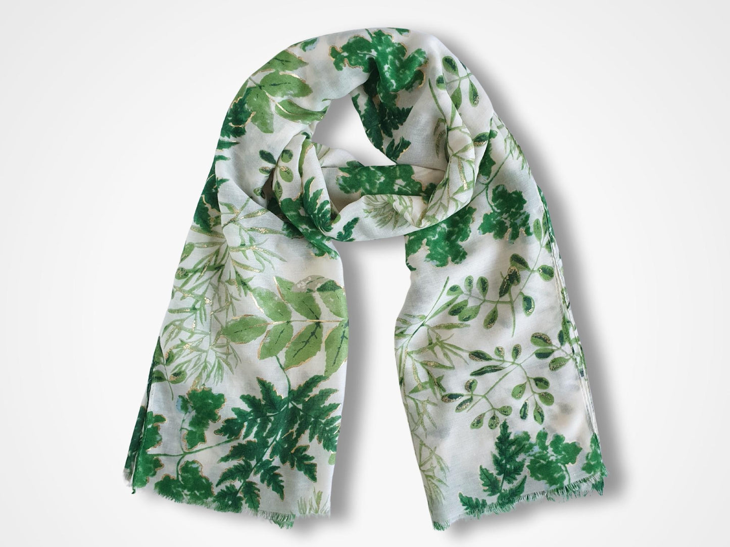 White scarf with green leaf pattern on a white background