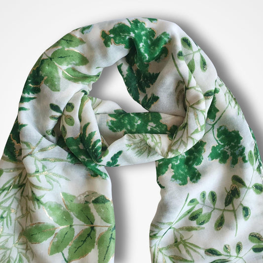 White scarf with green leaf pattern on a white background