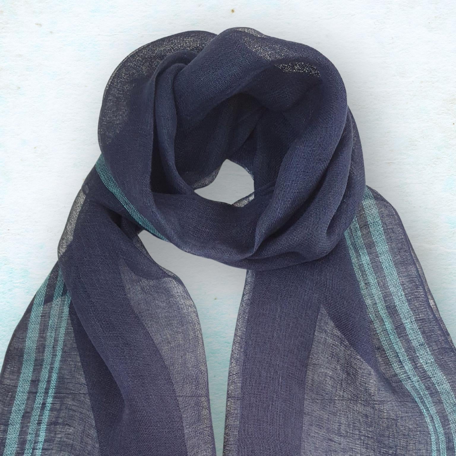Navy blue scarf with aqua accents on a light blue background
