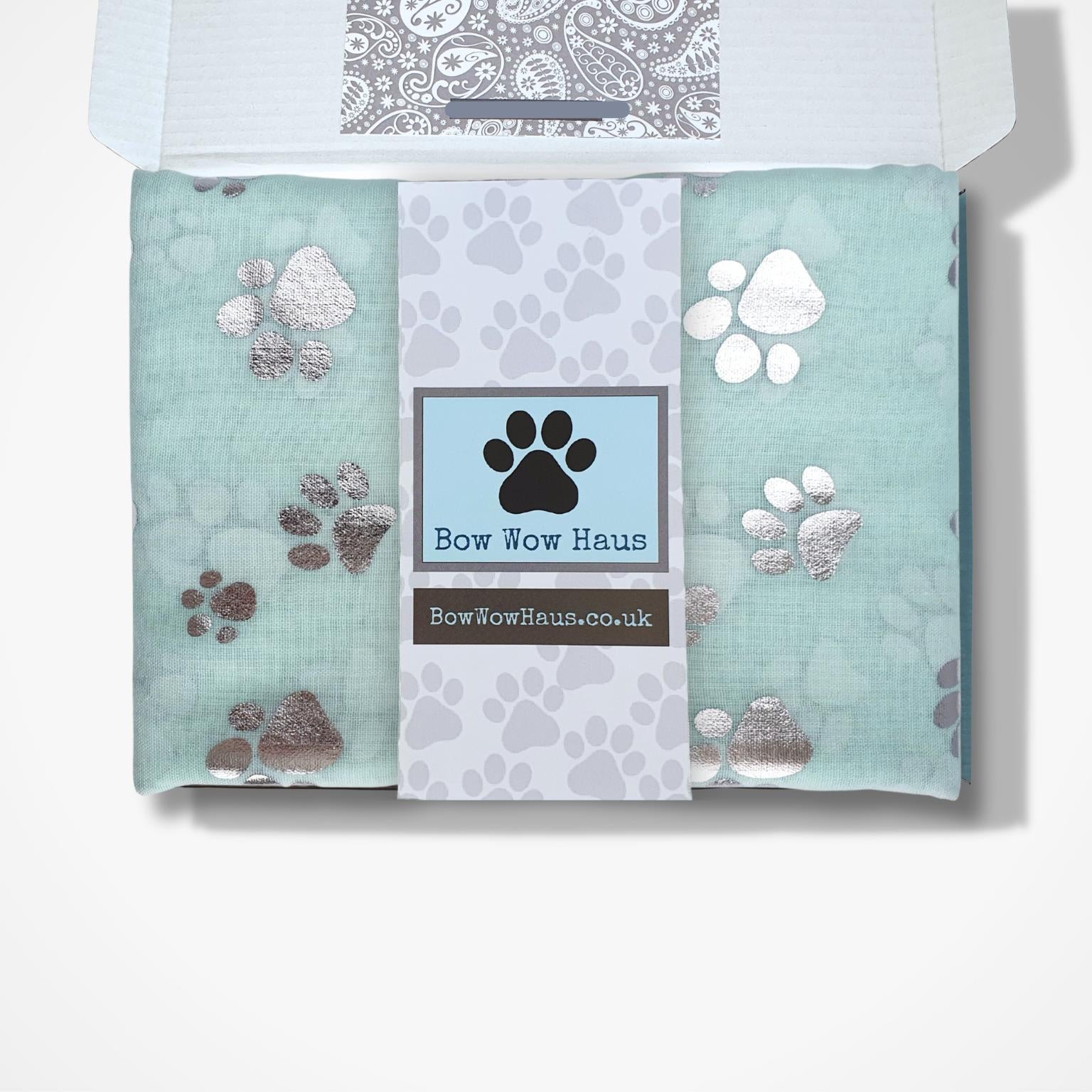 Gift boxed scarfs with paw prints and 'Bow Wow Haus' branding on a white background
