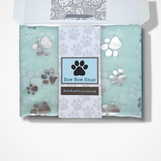 Gift boxed scarfs with paw prints and 'Bow Wow Haus' branding on a white background