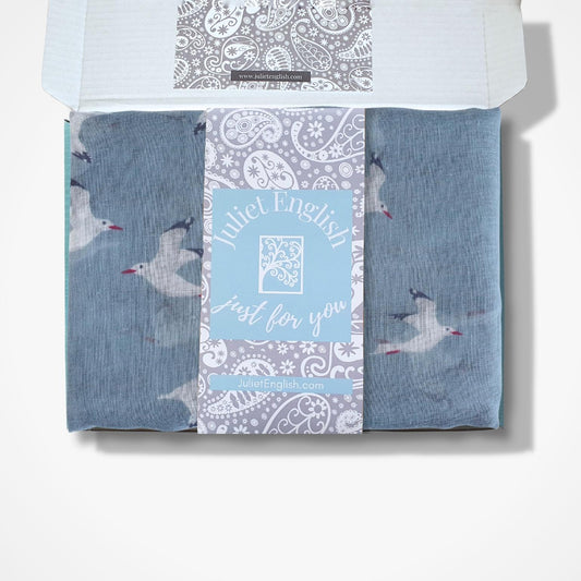 Scarf with bird design and Juliet English branding in a box on a white background