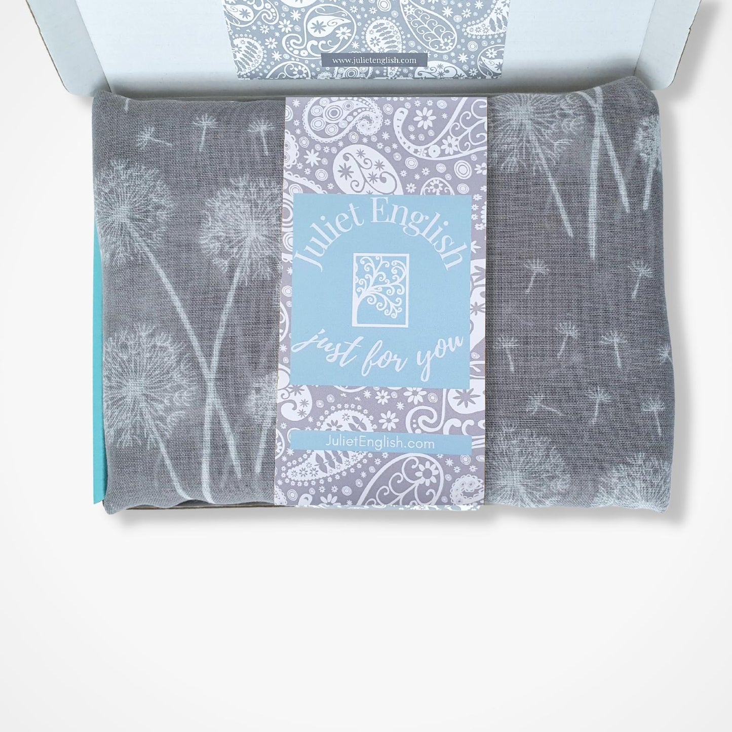 Packaged scarf with dandelion design and 'Juliet English' branding on a white background