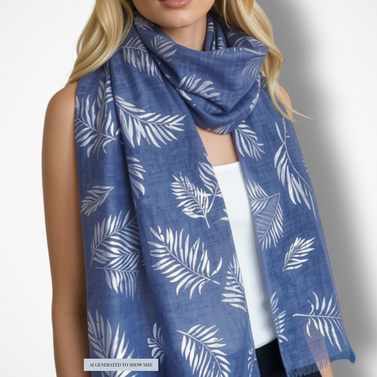 A woman wearing a blue scarf with a white leaf pattern, styled over a white top against a light gray background.