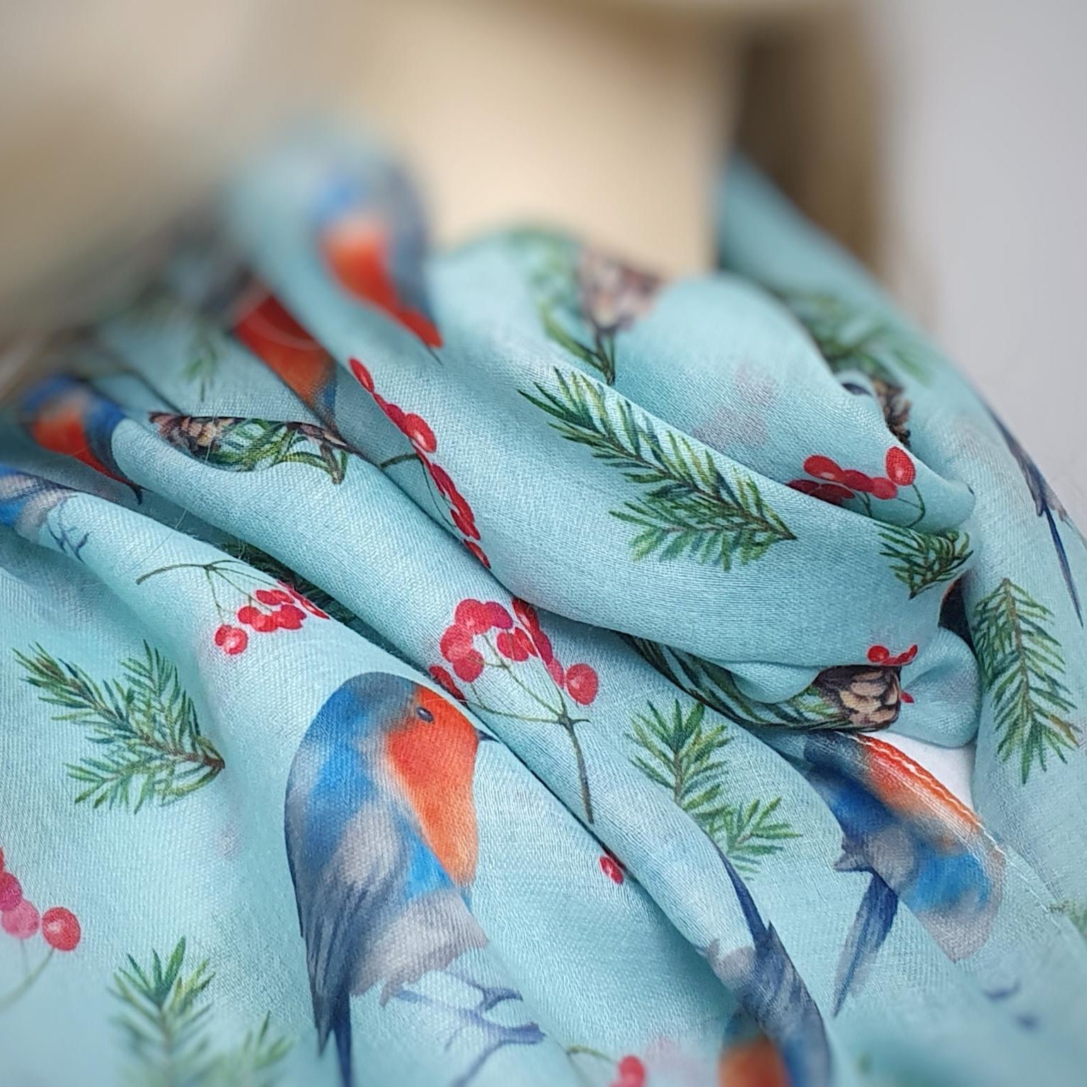 Scarf with robin and berries pattern on a light blue background