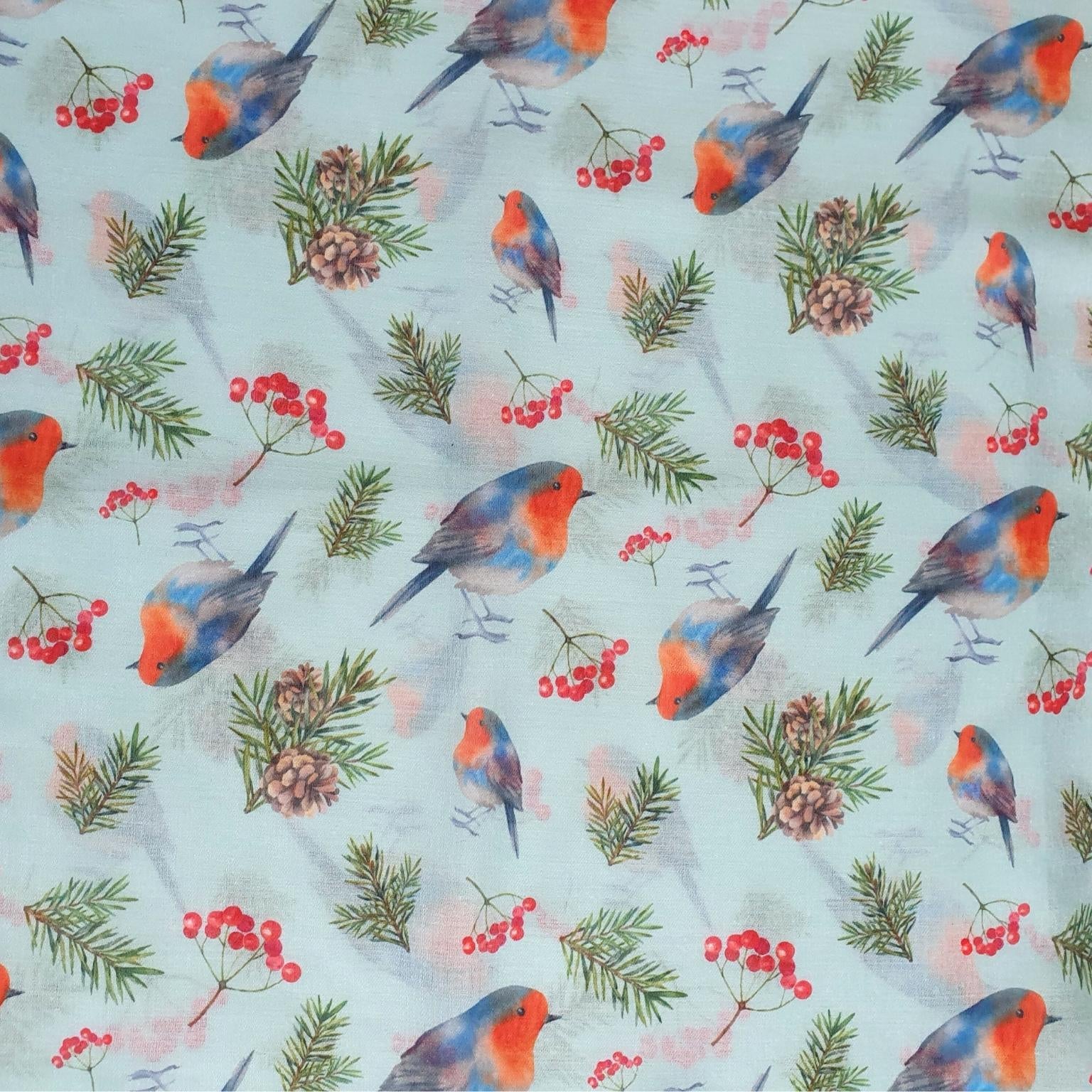 Pattern of colourful robins and berries on a light blue background