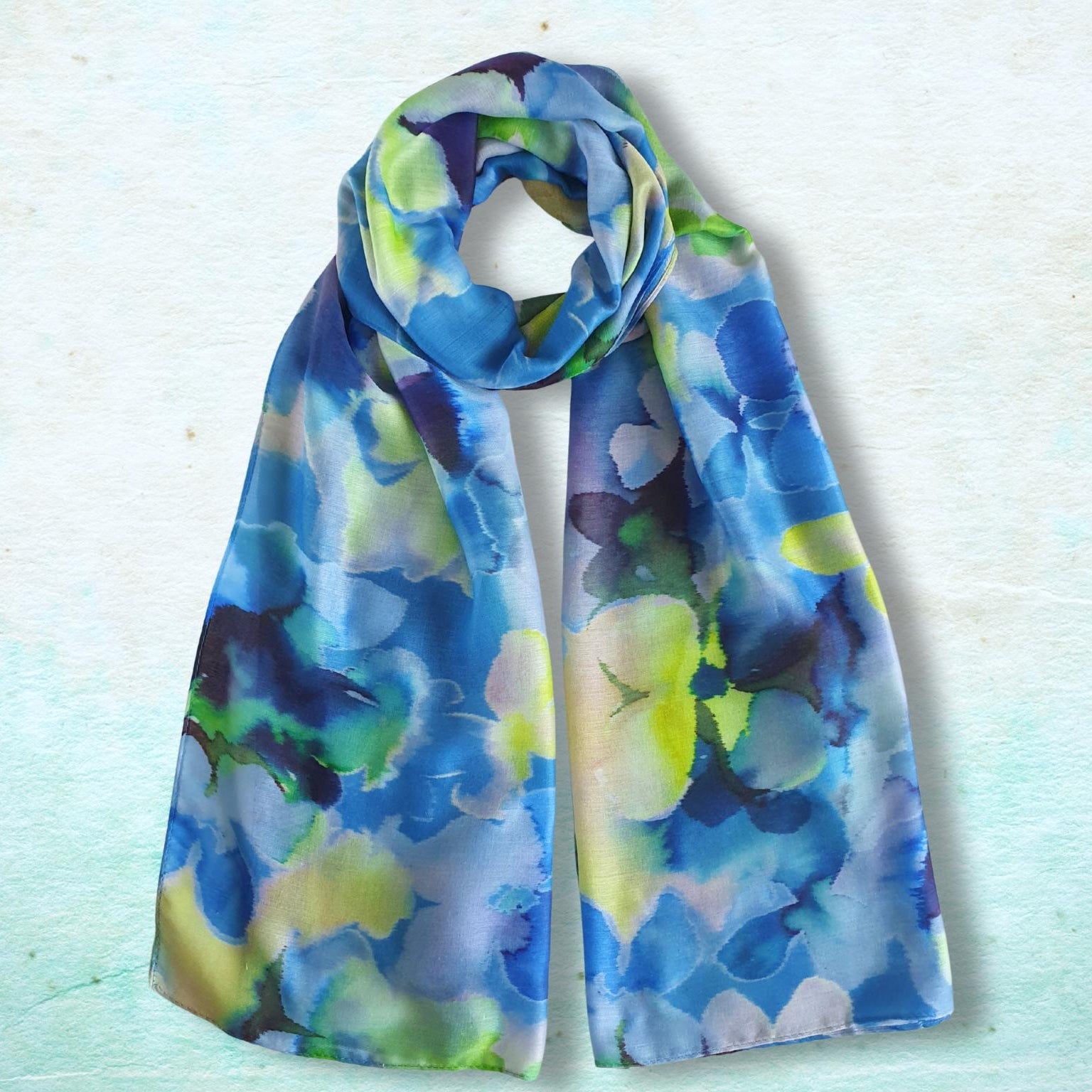 Colorful floral-patterned scarf on a light blue background