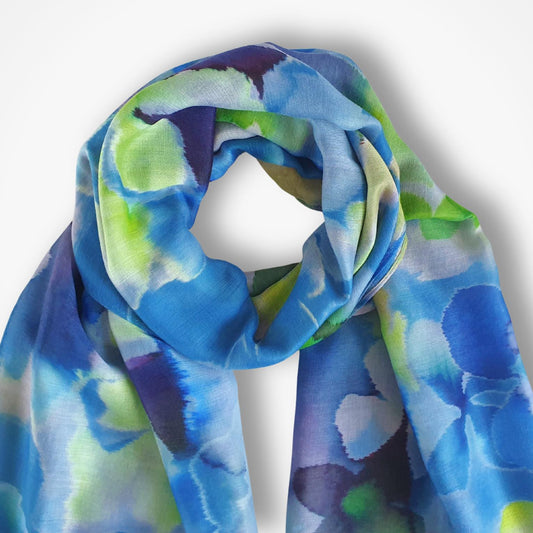 Colorful scarf with blue, green, and purple pattern on a white background