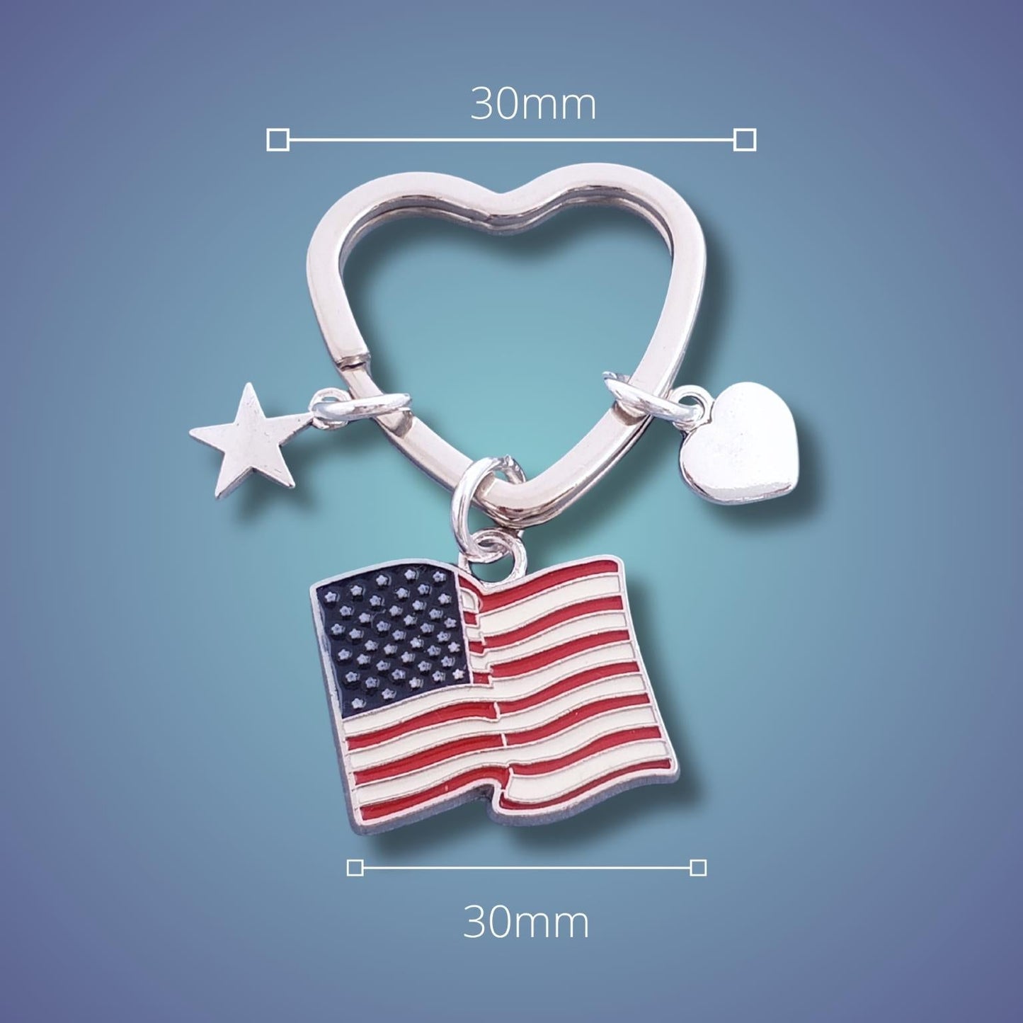 Silver heart-shaped keychain with American flag charm on a blue background