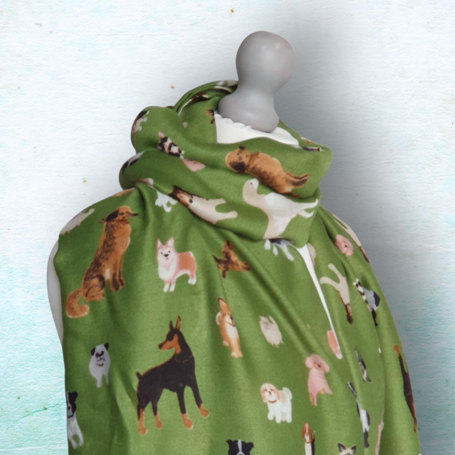 Green fabric wrap with dog pattern on a mannequin against a light blue background