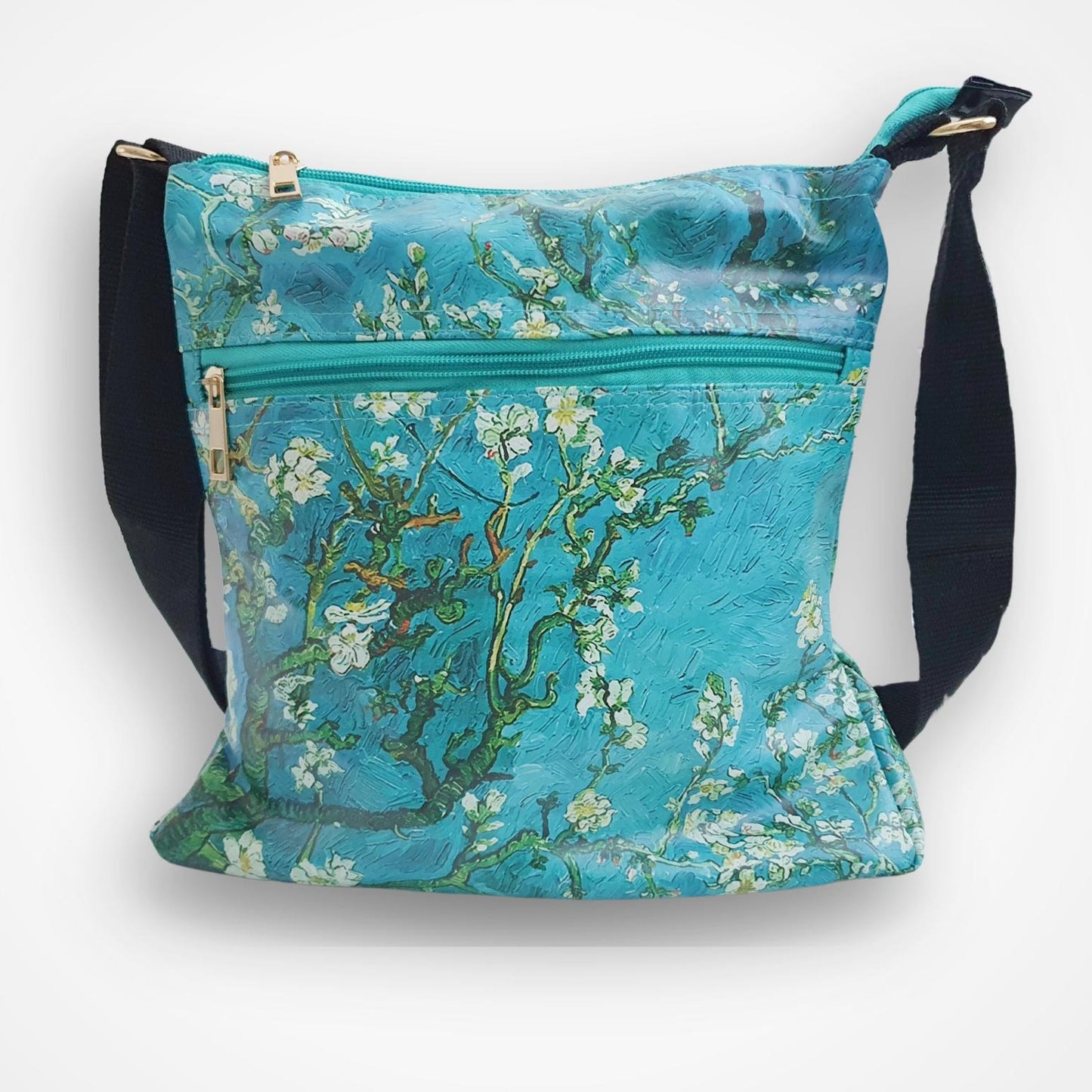 A crossbody shoulder bag featuring a print of Van Gogh's 'Almond Blossom' painting in vibrant turquoise, blue, and white, with black adjustable straps and gold-tone hardware, shown against a plain white background.