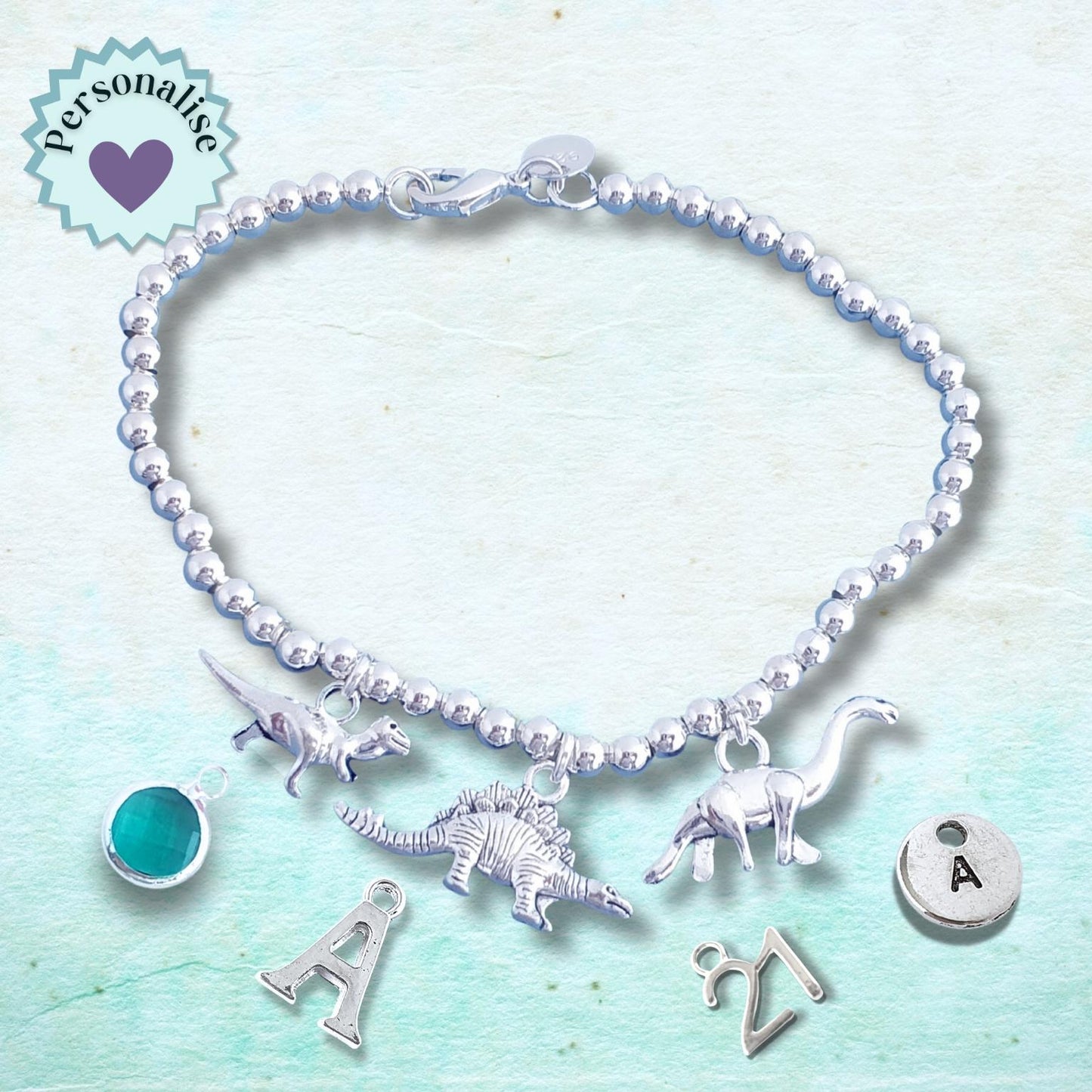 Bracelet with dinosaur charms on a light blue background